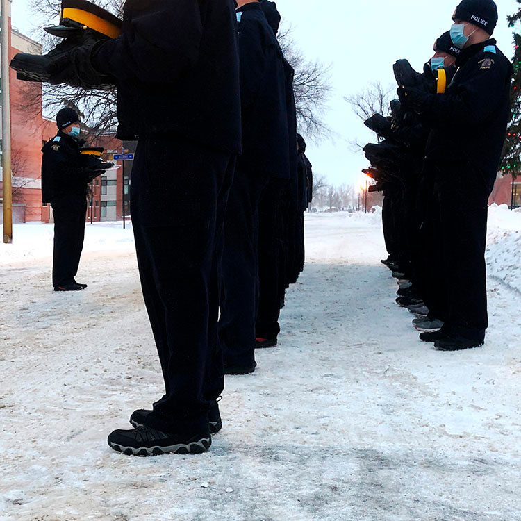 Cadets lined up outside holding their first kit issue