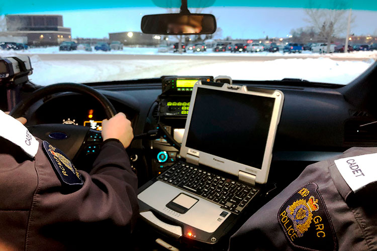 Two cadets in a police car