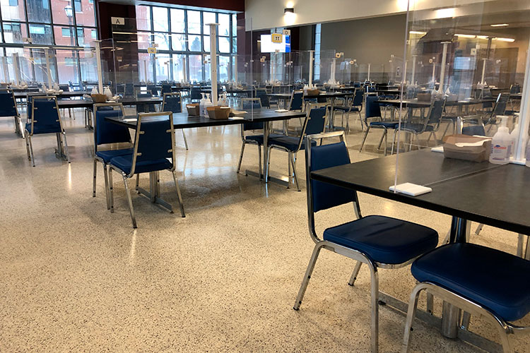 Tables and chairs set up at the Mess with COVID-19 barriers.