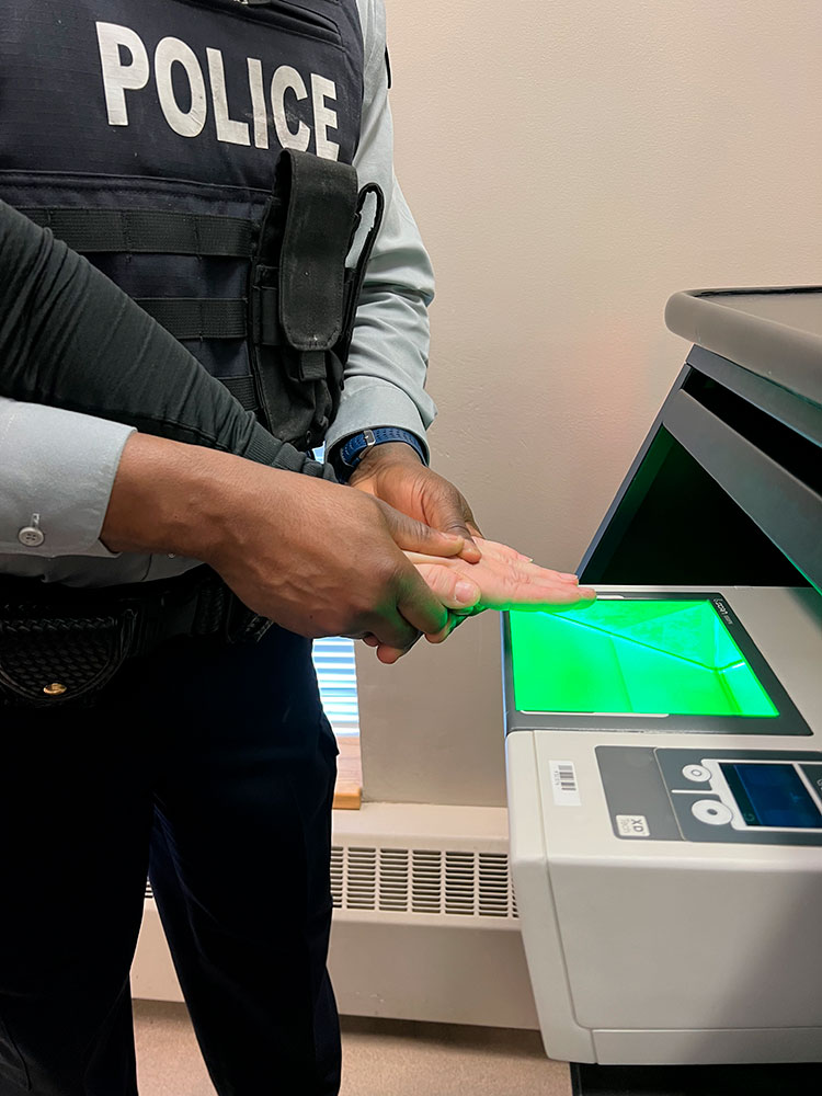 A cadet uses a Live Scan machine for fingerprinting.