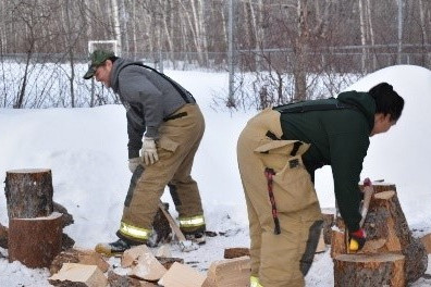 2 Fire fighters chop wood