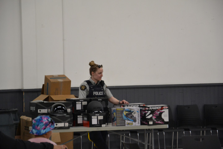 RCMP officers at a table with helmets