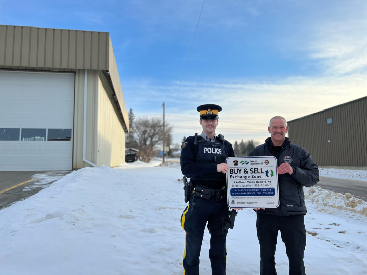 Cst. Harlow-Fossum with Battlefords RCMP and the North Battleford City's Director of Protective Services/Fire Chief, Lindsay Holm standing in front of the Buy & Sell Exchange Zone, located on the south side of the North Battleford Fire Department. 