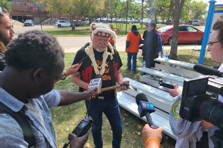 Master carver, Stanley Hunt, being interviewed by media 