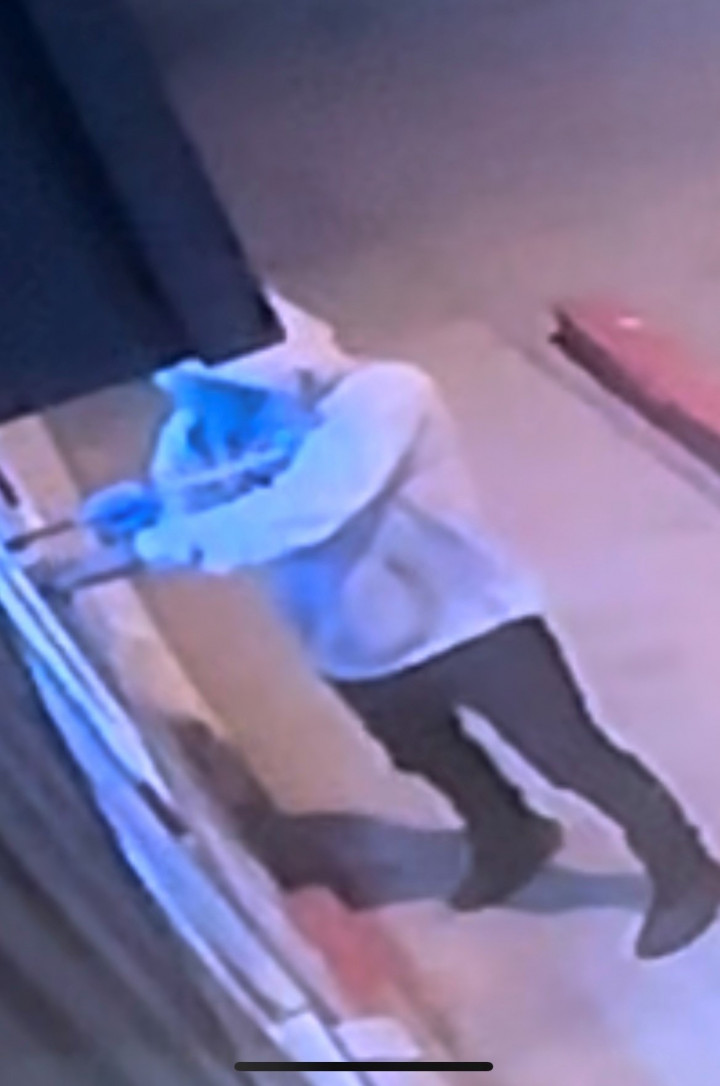 A man is shown breaking into a building. 