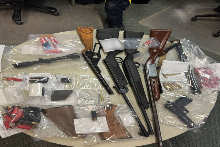 Officers located and seized a shot gun, two rifles, two replication firearms, a rifle scope, ammunition, a baton, and two sawed-off firearm buttstocks at the residence. 