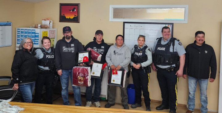 Group photo of Sweetgrass First Nation Security Team and Sask. RCMP officers