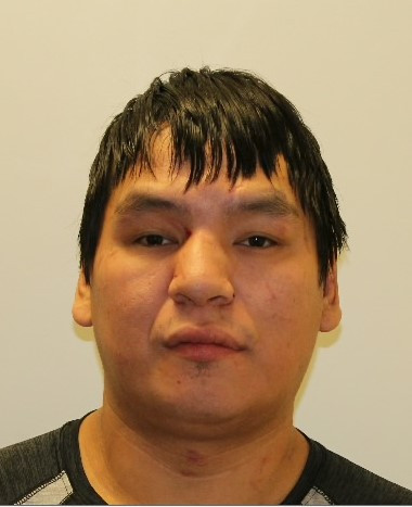 A headshot of a man with dark hair and dark brown eyes.