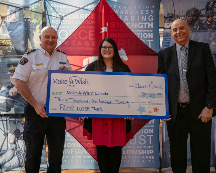 Three people with the Make-A-Wish cheque.